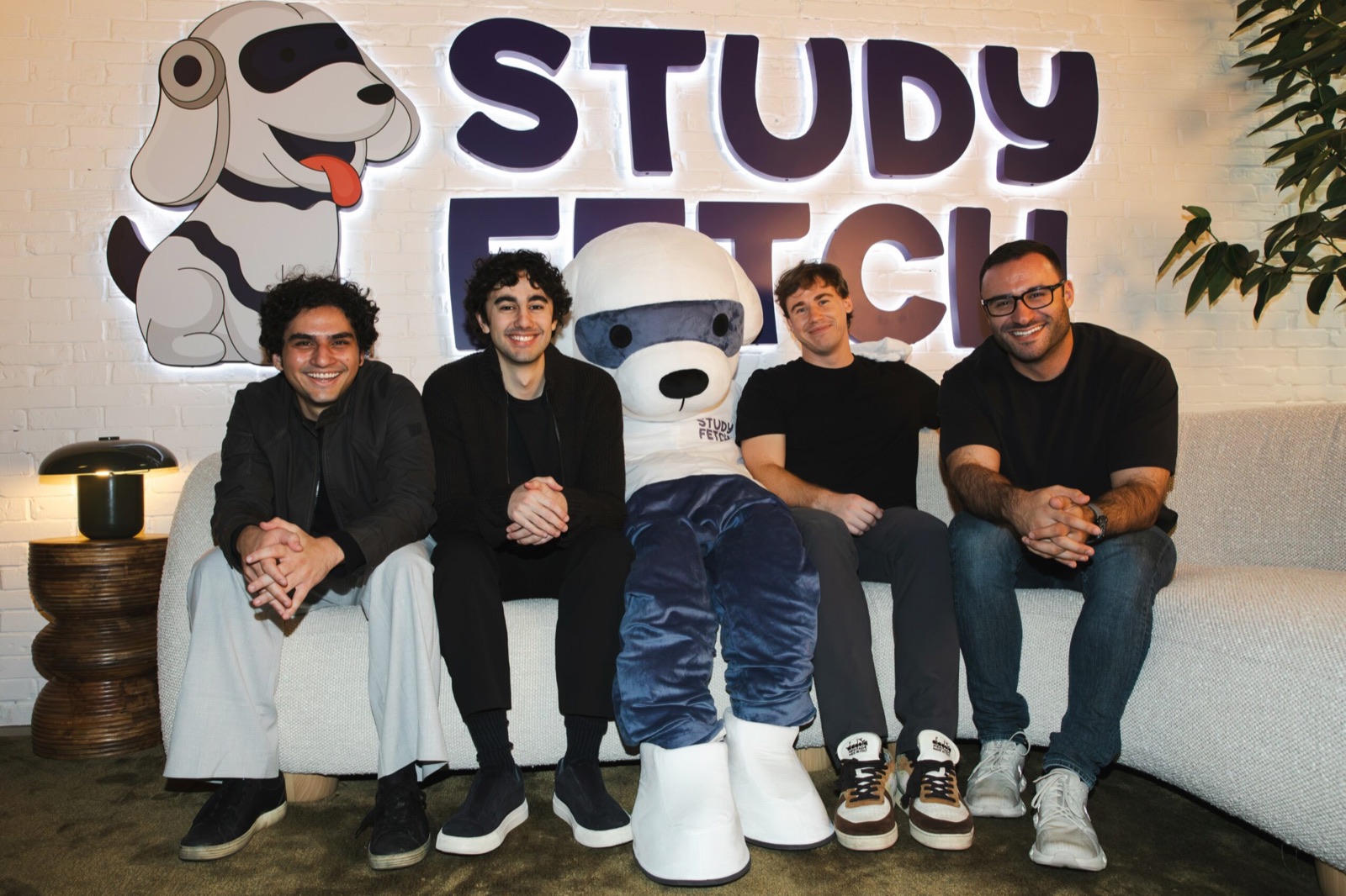 StudyFetch cofounders Esan Durrani and Ryan Trattner, with Josh Leggett, COO, and Kiran Desai, CMO, seated under the StudyFetch sign